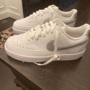 Nike Court Vision sneakers with a silver metallic swoosh